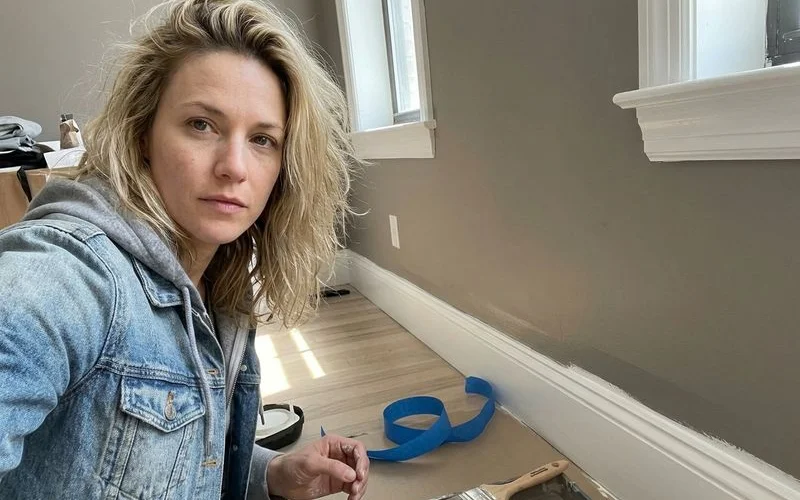 Crisp line between a freshly painted wall and white semi-gloss baseboard