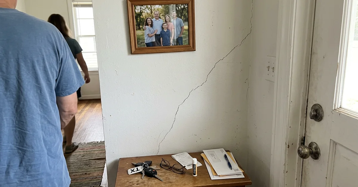 Diagonal hairline crack running from a door corner in a Texas home's drywall