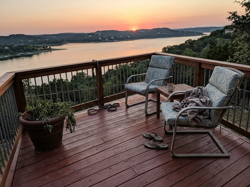 Freshly stained backyard deck with patio chairs overlooking the hills