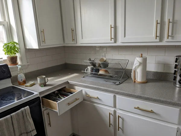 After: the same kitchen with smooth painted cabinets and new hardware