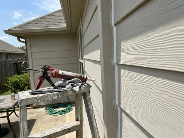 Fresh caulk bead along a siding joint