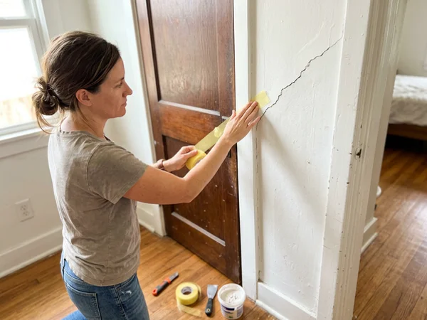 Taping a diagonal crack at a door corner