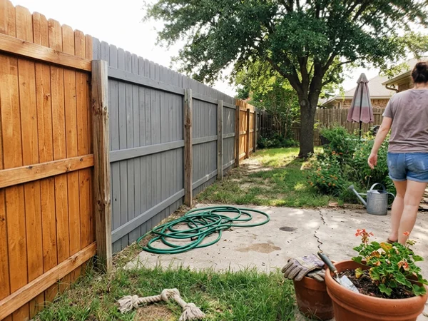 Semi-transparent and solid stain side by side on a fence
