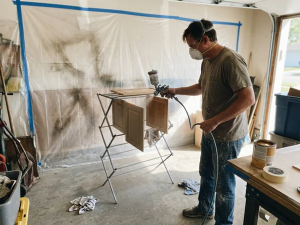 Spraying a cabinet door with an HVLP gun
