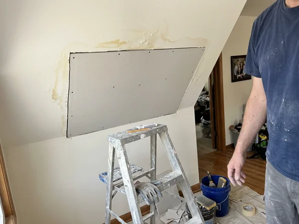 Water-damaged ceiling section replaced with new drywall